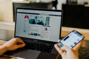 Laptop and smartphone with social media apps open